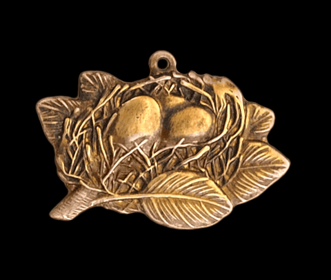 Brass Stamping of a small bird's nest to be used as a charm